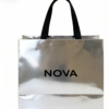 Close-up-of-silver-mirror-foil-paper-tote-bag-with-black-ribbon-handle-luxury-retail-packaging-detail-with-custom-brand-printing