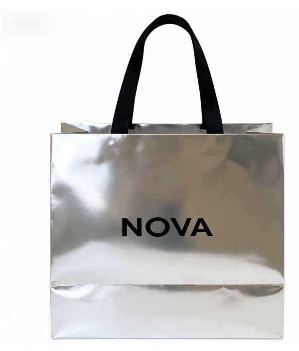 Close-up-of-silver-mirror-foil-paper-tote-bag-with-black-ribbon-handle-luxury-retail-packaging-detail-with-custom-brand-printing