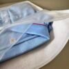 reathable non woven zipper bag holding blue polo shirt retail packaging effect