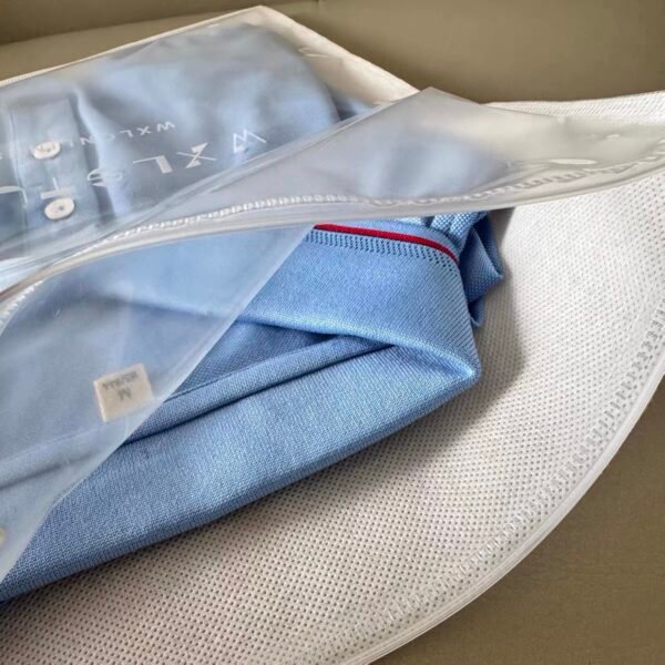 reathable non woven zipper bag holding blue polo shirt retail packaging effect