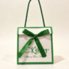 Custom fold over gift paper bag with matching satin ribbon bow and twisted rope handle