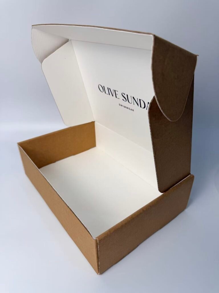 Open kraft mailer box with custom inner print for swimwear brand packaging