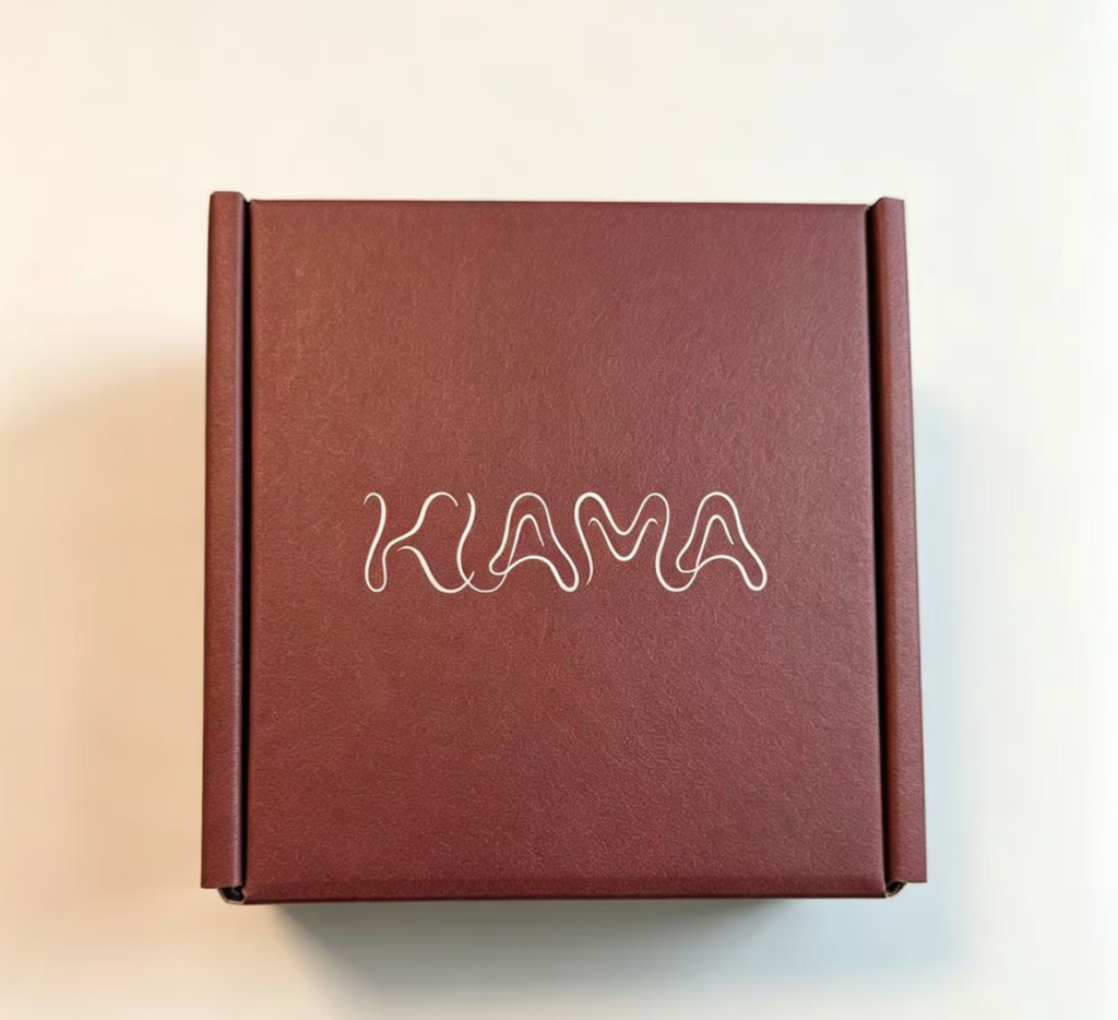 Burgundy rigid gift box with custom KAMA logo, matte paper texture packaging for jewelry and small brand gifting